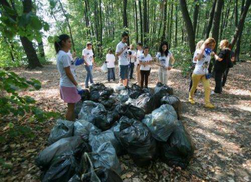 Volunteers of 'Let's do it Romania!' finish cleaning up the forest of Mogosoaia near Bucharest on September 24, 2011