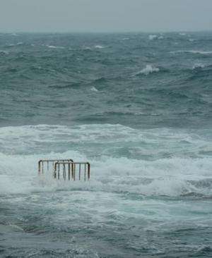 Waves cover the ladder of a swimming pool at Hoping island, in Keelung, northern Taiwan as Typhoon Fitow approached on October 5