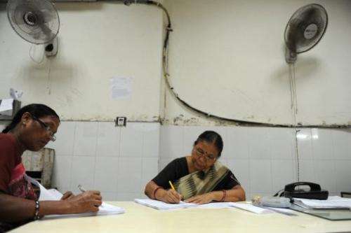 Workers go about their business at the Central Telegraph Office in New Delhi on July 10, 2013