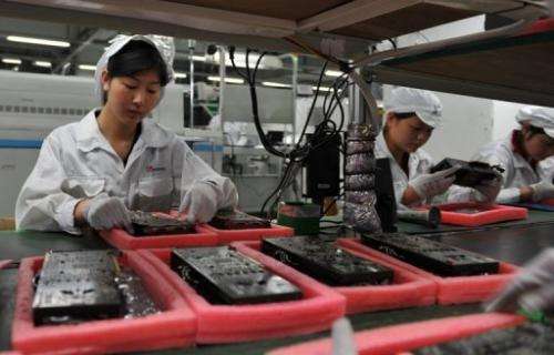 Workers inspect motherboards on a factory line at the Foxconn plant in Shenzen, southern China on May 26, 2010