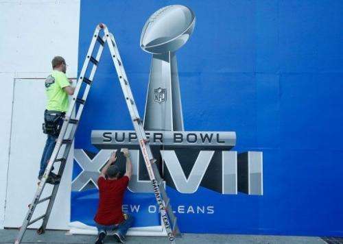 Workers put the finishing touches to a Super Bowl sign, on January 29, 2013, in New Orleans