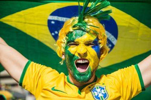 A Brazil fan cheers for his team outside the Mineirao stadium in Belo Horizonte, southern Brazil on June 28, 2014 before the Wor