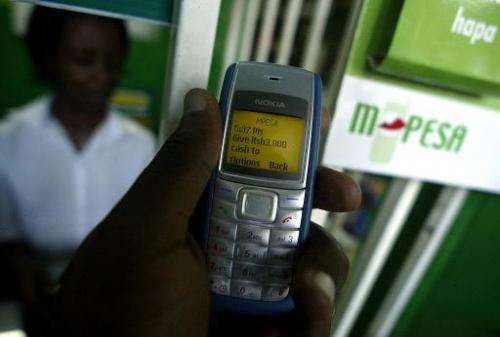 A customer is seen sending money through a mobile phone service called M-Pesa, in Kenya's capital Nairobi, on April 23, 2007