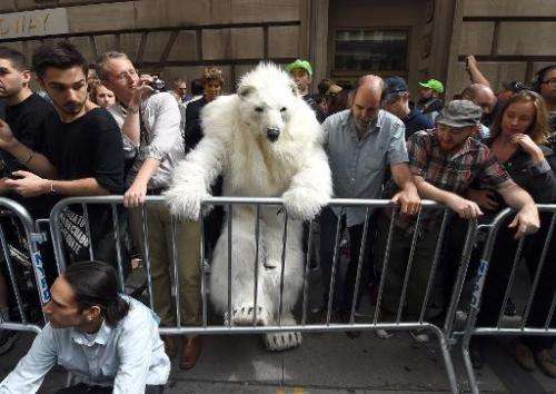 A man dressed as a polar bear climbs a barricade as protestors take part in the &quot;Flood Wall Street&quot; demonstrations on 