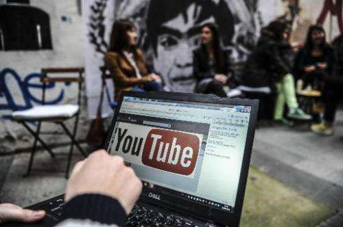 A man looks at the YouTube site on a laptop in Istanbul, on March 27, 2014