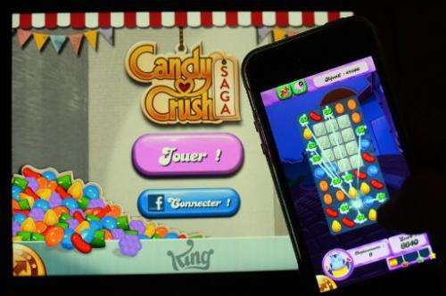 A man plays Candy Crush Saga on his iPhone on January 25, 2014