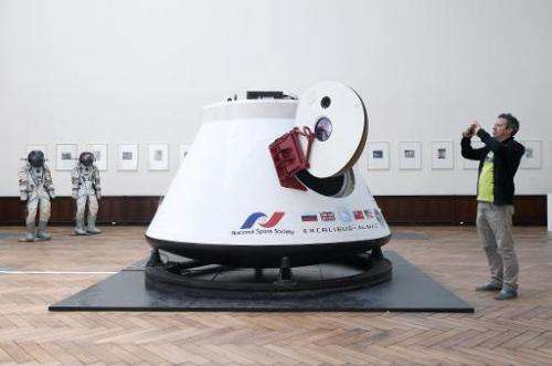 A man takes a picture of the Soviet space capsule Vozvrashchayemi, on May 5, 2014, in Brussels