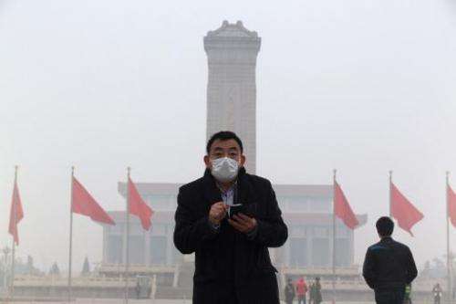 A man walks through a haze-shrouded Tiananmen Square  in Beijing on February 23, 2014