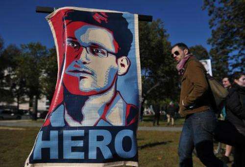A picture taken on October 26, 2013 shows a portrait of Edward Snowden declaring him a &quot;hero&quot; during a protest against