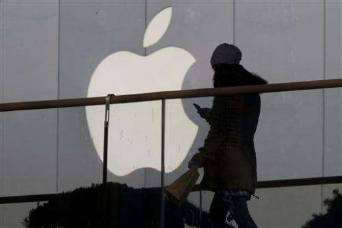 Apple increases stock buyback, will split stock