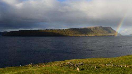 A rainbow appears above the Hestur island on October 16, 2012, Faroe Islands