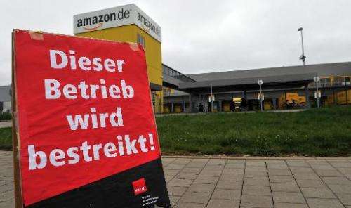 A sign reads &quot;this site is on strike&quot; in German in front of the logistics center of US online retailer Amazon in Grabe