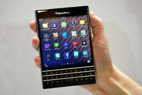 A woman holds the Blackberry Passport smartphone at a launch event in London on September 24, 2014