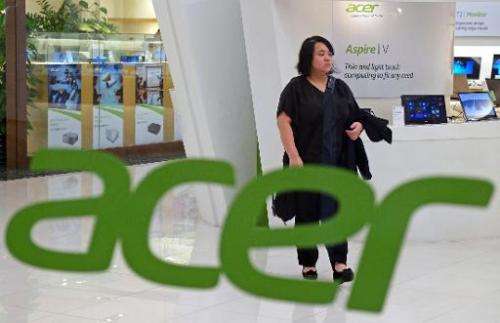 A woman walks inside an Acer show room in New Taipei City. The struggling personal computer maker posts a net profit of Tw$651 m
