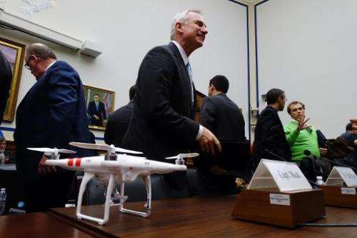Captain Lee Moak, president of the Air Line Pilots Association, stands behind a DJI Phantom 2 drone after testifying in Washingt