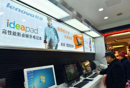 Chinese customers check out the computers at a Lenovo shop in Hangzhou, Zhejiang province on February 2, 2014