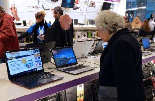 Customers look at computers displayed at a FNAC store on November 27, 2012 in Paris
