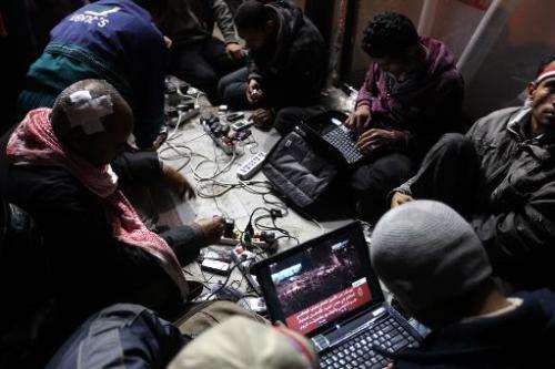 Egyptian anti-government bloggers work on their laptops from Cairo's Tahrir Square on February 10, 2011