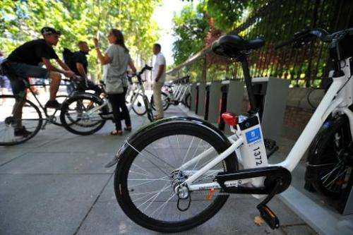 Electric bicycles are parked at a bike-sharing station in Madrid on June 23, 2014