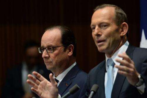 French President Francois Hollande (L) and Australian Prime Minister Tony Abbott hold a press conference at Parliament House in 