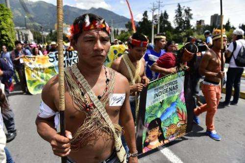Huaorani natives and ecologist group activists march in Quito, Ecuador, on April 12, 2014, toward the National Electoral Council