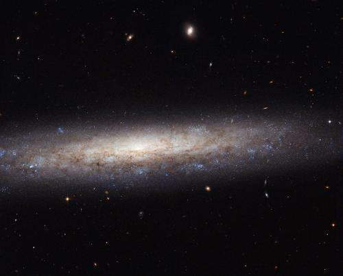 Image: Hubble catches a dusty spiral in Virgo