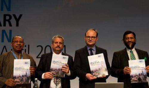 Intergovernmental Panel on Climate Change (IPCC)pose with a copy of the IPCC report &quot;Climate Change 2014, Mitigation of Cli