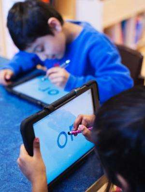 Nursery school pupils work with iPads on March 3, 2014 in Stockholm