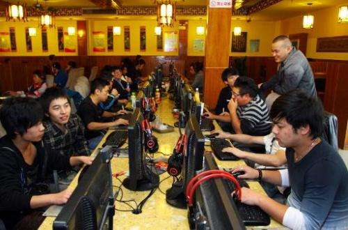 People are seen at an Internet cafe in Jiashan, east China's Zhejiang province, on November 2, 2012