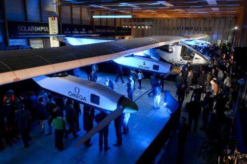 People look at the second Solar Impulse experimental solar-powered plane, the HB-SIB, to be used for a round-the-world voyage ne