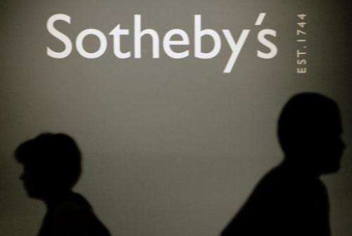 People pass by a Sotheby's auction house logo in the Russian History Museum in Moscow, May 23, 2007