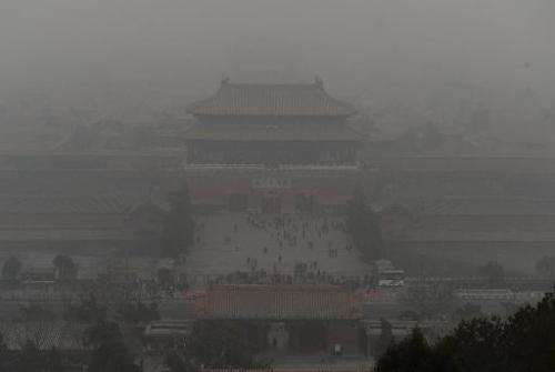 People visit the Forbidden City as heavy air pollution continues to shroud Beijing on February 26, 2014