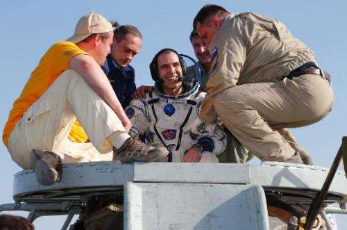 Russian space agency rescue team help US astronaut Rick Mastracchio shortly after landing, about 150 km ( 80 miles) south-east o