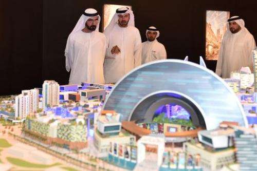 Sheikh Mohammed of Dubai (left) looks at a mock-up of the &quot;Mall of the World&quot; project during its presentation in Dubai