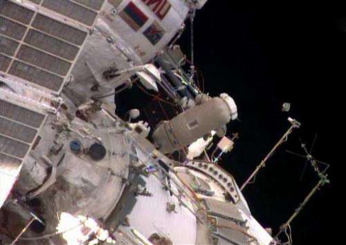 Spacewalking astronauts release baby satellite (Update)