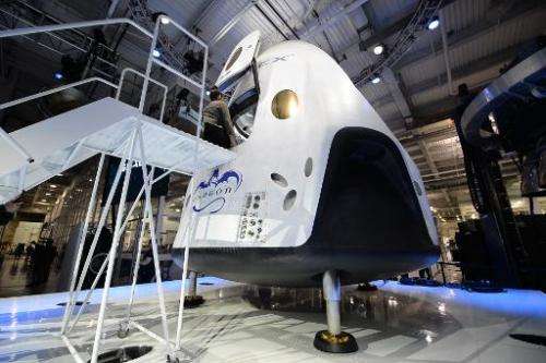 SpaceX's new seven-seat Dragon V2 spacecraft is seen at a press conference to unveil the new spaceship, in Hawthorne, California