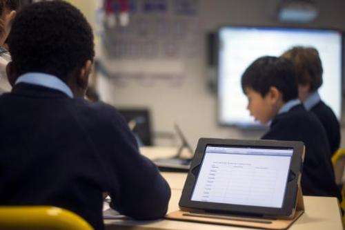 Students use tablets at a school in Paris on December 3, 2012