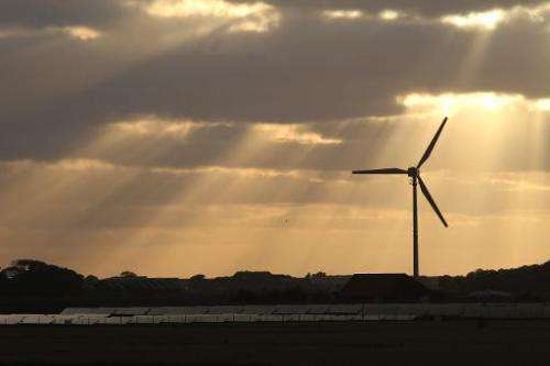 The sun shines on a wind and a solar hybrid parc on Pellworm island, northern Germany, on August 9, 2013
