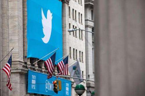 The Twitter logo is displayed on a banner outside the New York Stock Exchange (NYSE) on November 7, 2013