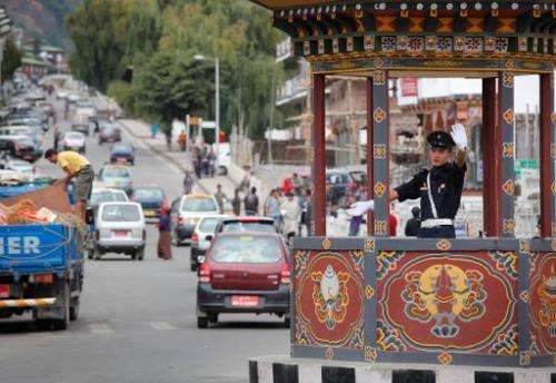 This file photo shows a trafffic warden directing traffic in the Bhutanese capital city of Thimphu, on October 4, 2010