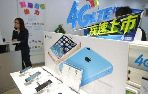 This picture taken on January 14, 2014, shows an Apple iPhone advertised in a China Mobile store in Shanghai