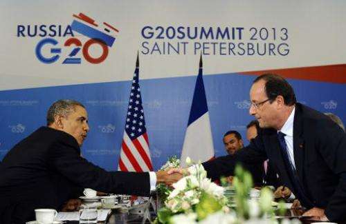 US President Barack Obama (L) shakes hands with French President Francois Hollande during a bilateral meeting in Saint Petersbur