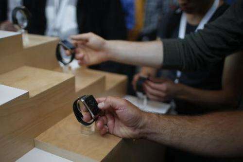 Visitors check out Samsung Gear Live watches during the Google I/O Developers Conference at Moscone Center in San Francisco, Cal