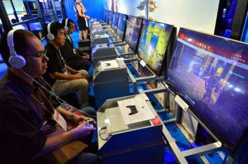 Visitors play Sony's PS4 video game console at the Tokyo Game Show in Chiba, suburban Tokyo on September 18, 2014
