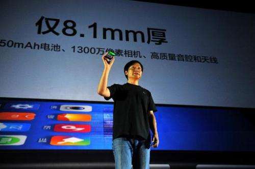 Xiaomi CEO Lei Jun shows a new Xiaomi smartphone at in Beijing on September 5, 2013
