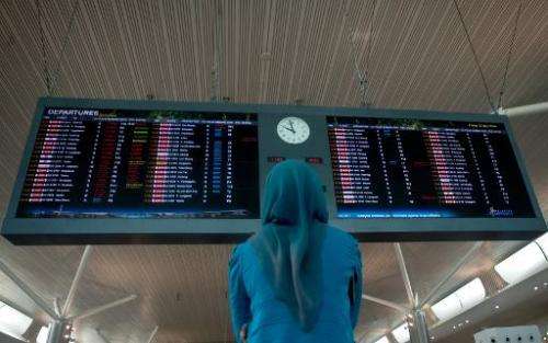 A woman looks at flight schedules at Kuala Lumpur International Airport 2 (KLIA2) in Sepang, outside Kuala Lumpur on May 2, 2014