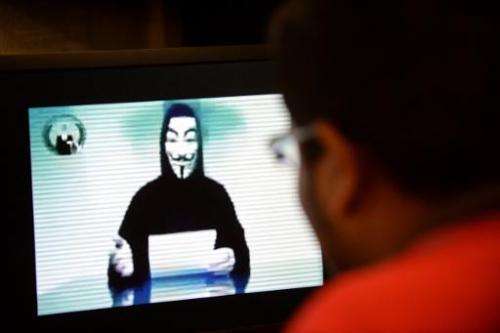File photo shows a person claiming to speak for activist hacker group Anonymous issuing a warning to the Singapore government ov