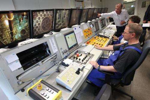 This photo taken on July 1, 2014 shows workers at the control room of the Nuclear Power Plant in Obrigheim, Germany