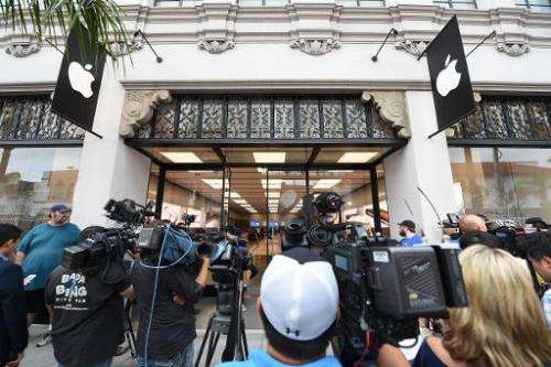 Members of the media gather outside the Apple store in Pasadena, California on September 19, 2014