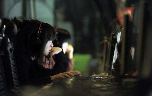 This photo taken on May 11, 2011 shows a Chinese young woman surfing the net at an Internet bar in Beijing